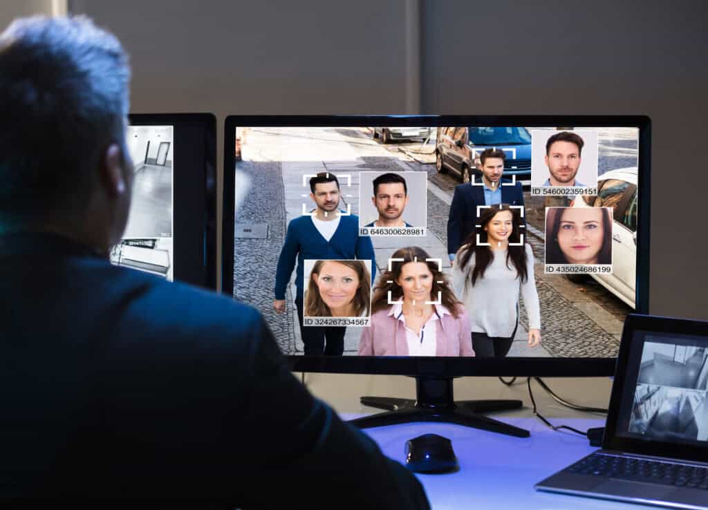man monitoring people shown on a camera feed as part of smart building security solutions